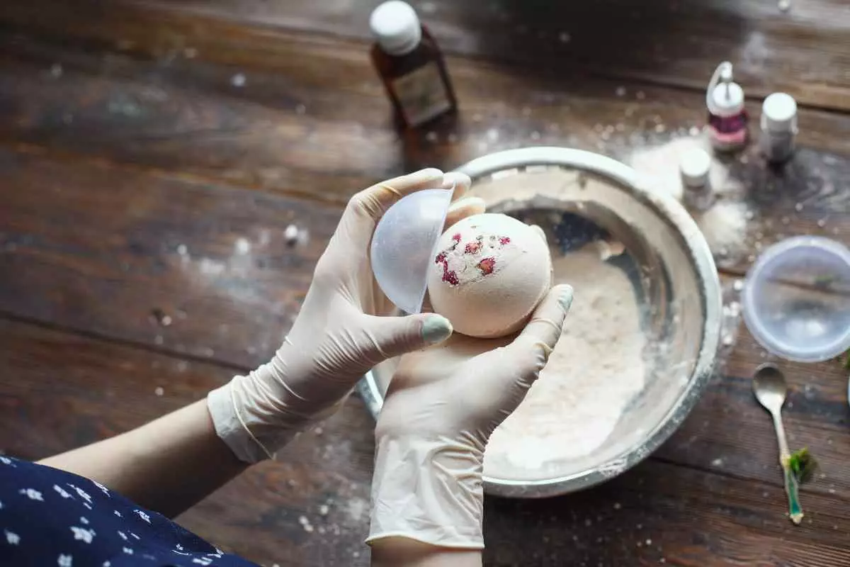 Individual making bath bombs.