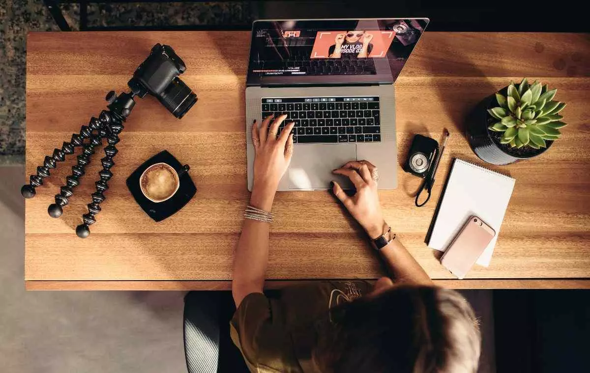 Overhead view of blogger working on laptop