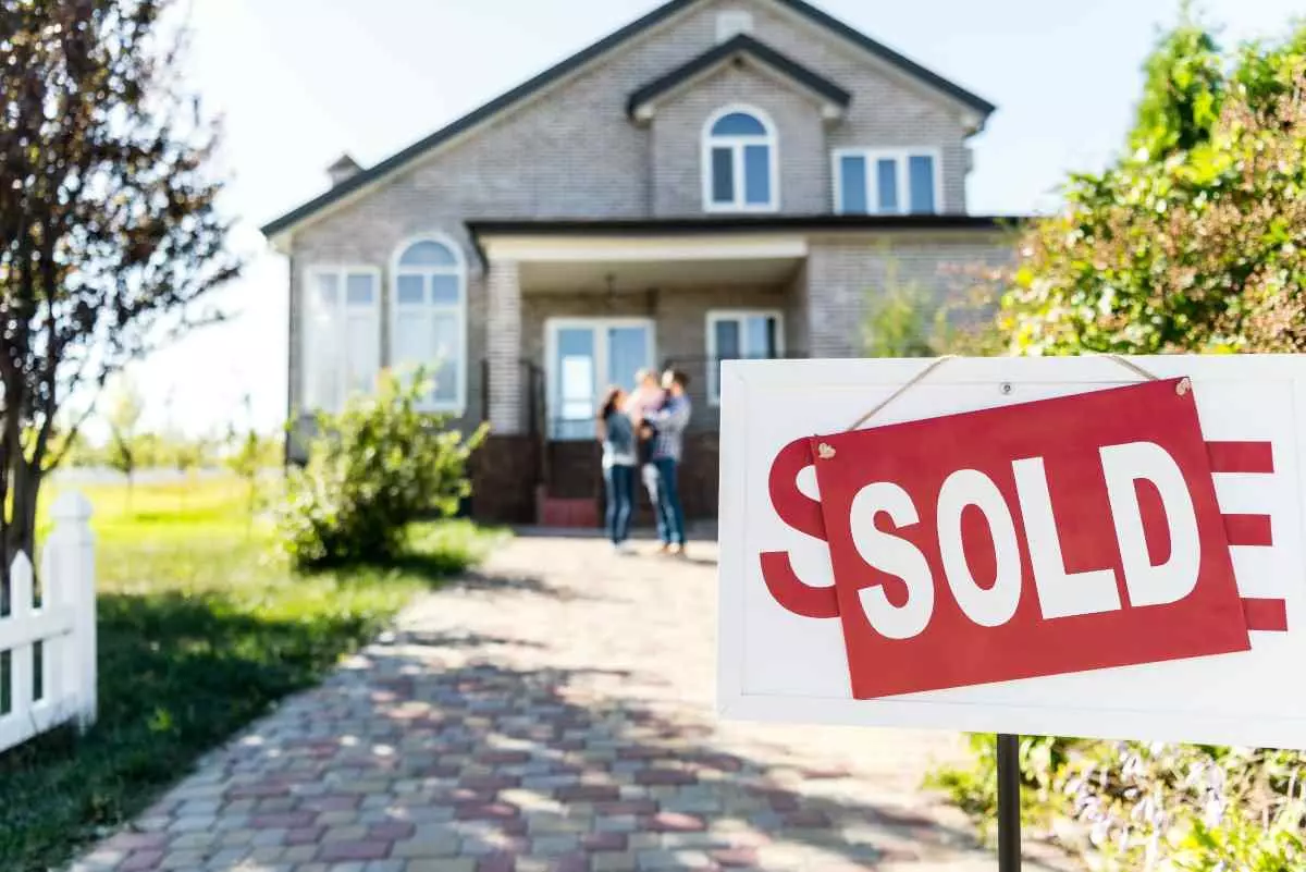 House with a sold sign in front.