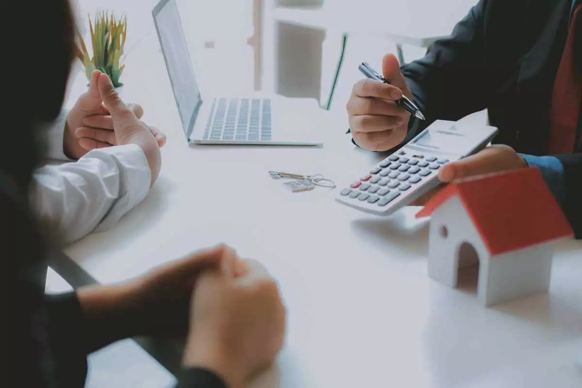 people consulting a financial advisor about mortgage payments