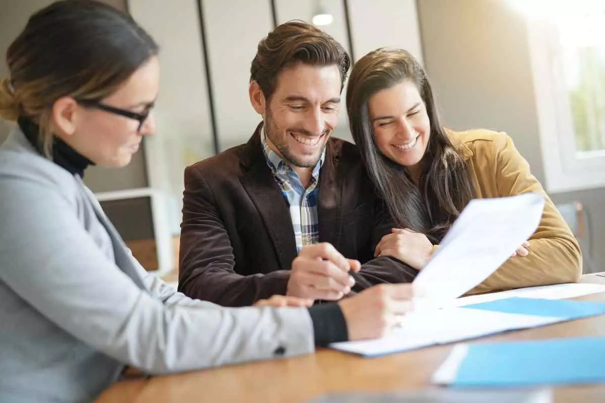 Smiling couple meeting with investment manager. 