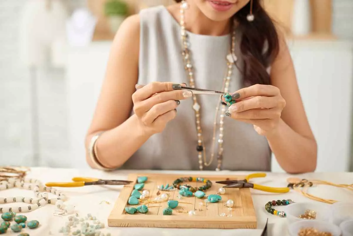 Individual making jewellery.