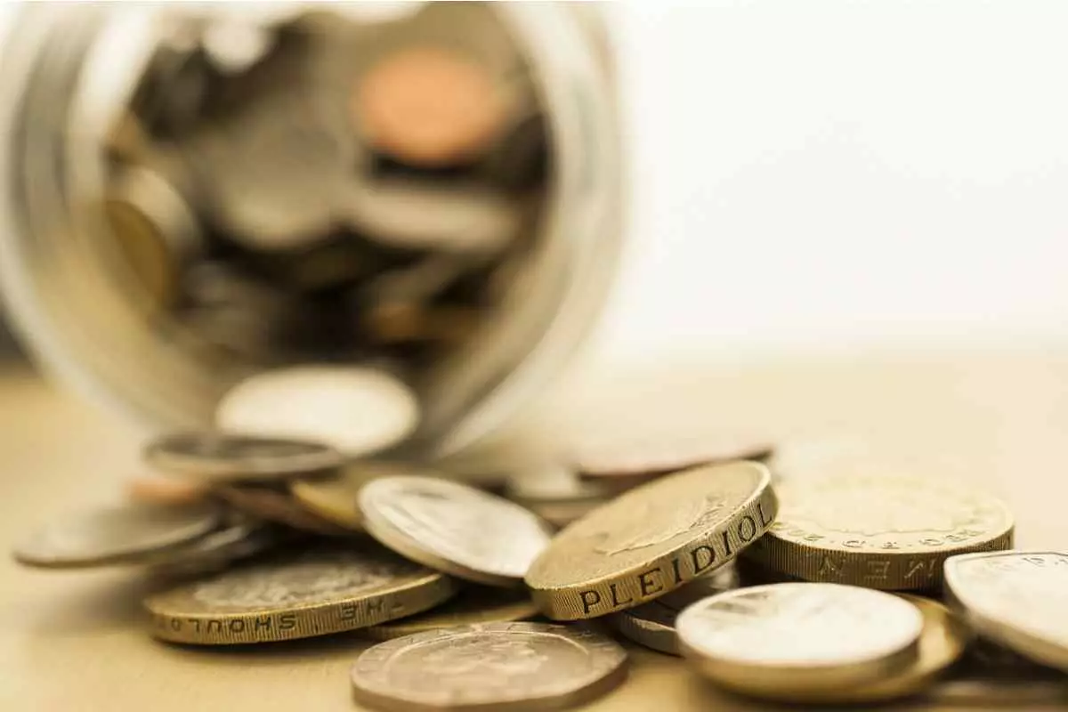 A jar filled with pound coins. Savings account concept