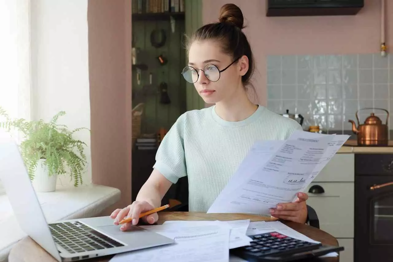 Young adult paying utility bills