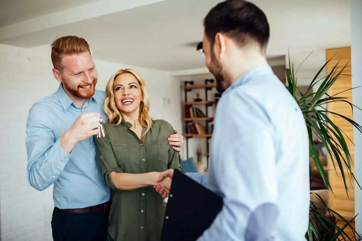 Property manager shaking hands with new tenants.