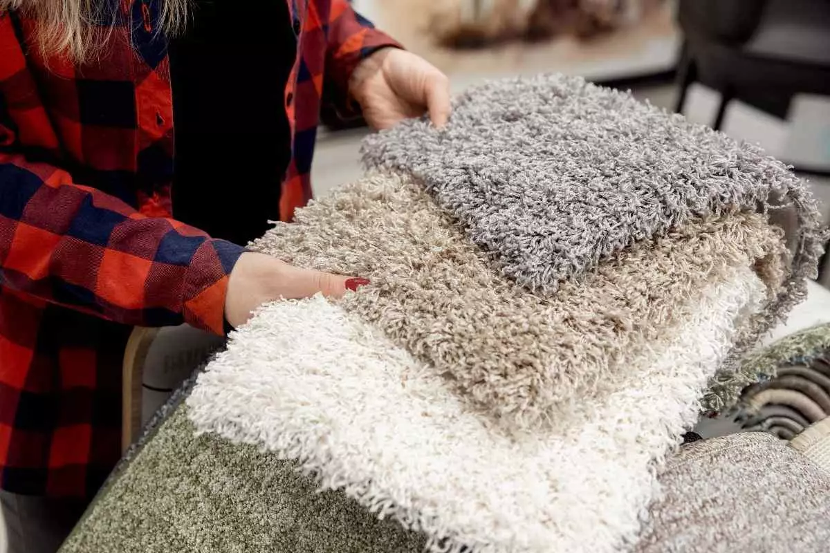 Individual choosing rug materials.