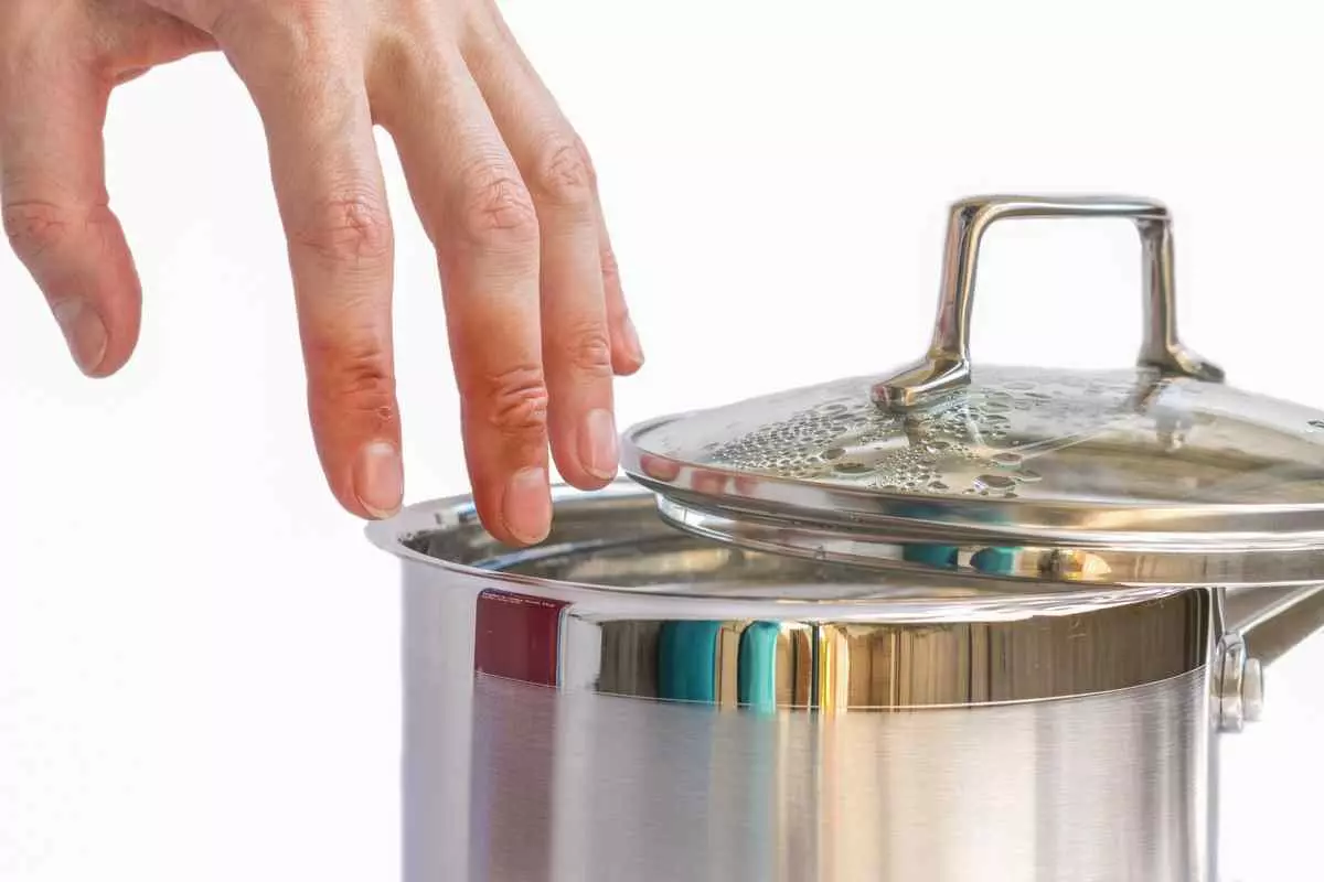 A hotel worker's hand over a pot with scald injuries.