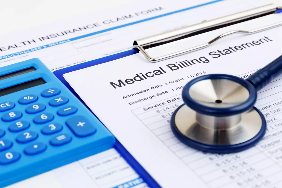 a stethoscope and a medical bill form.