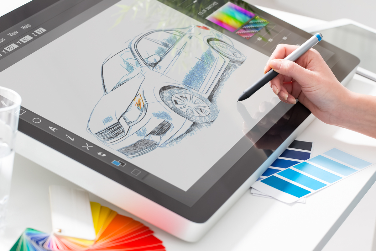Someone designing a car on a digital art tablet. 