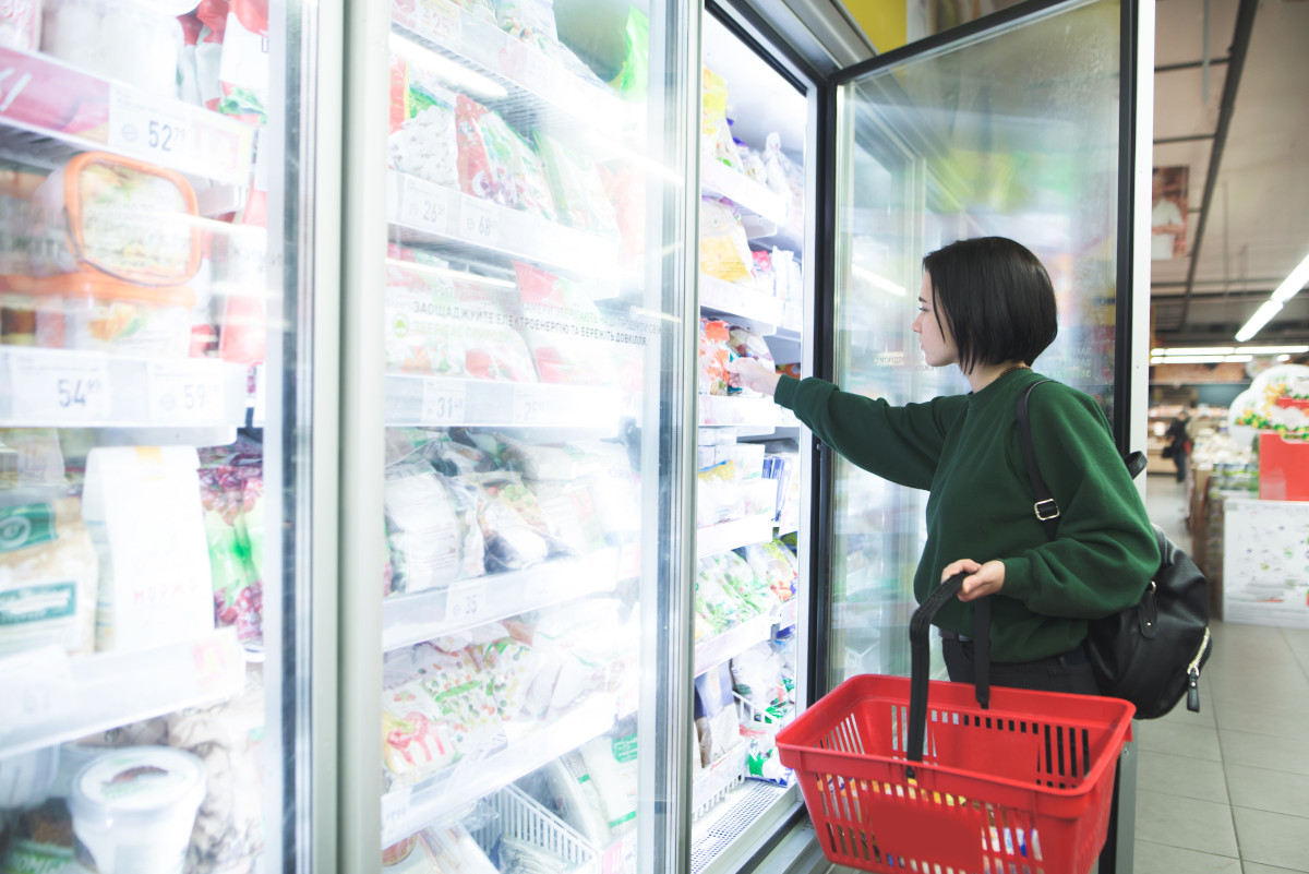 A shopper in the freezer section.