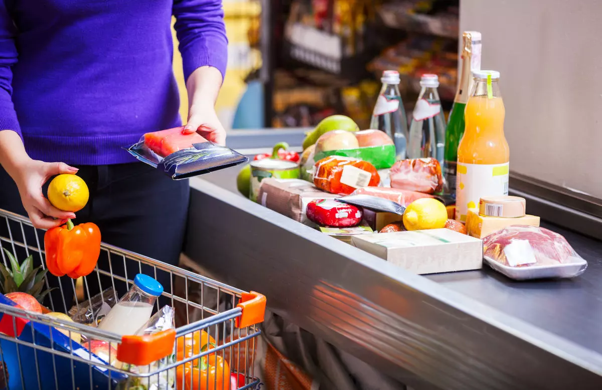 A woman checking out at a grocery store.