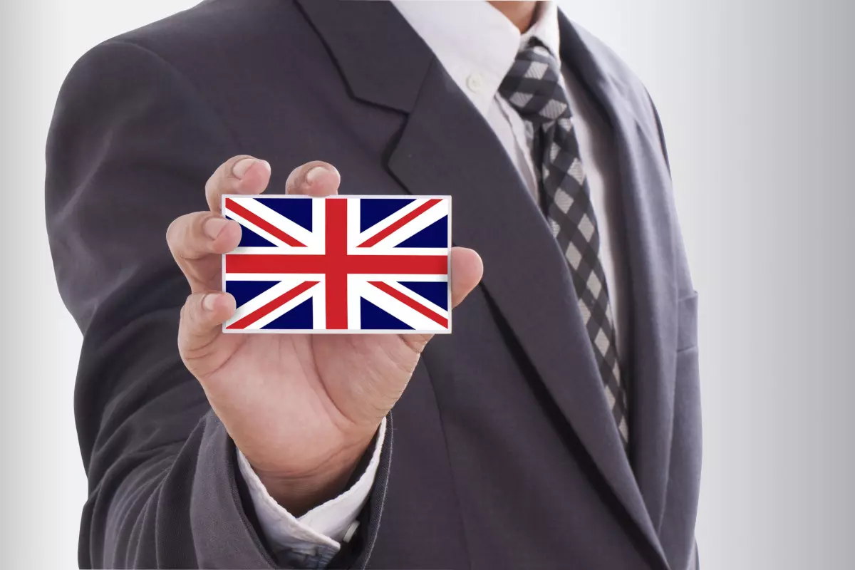 A government worker holding the UK flag. 