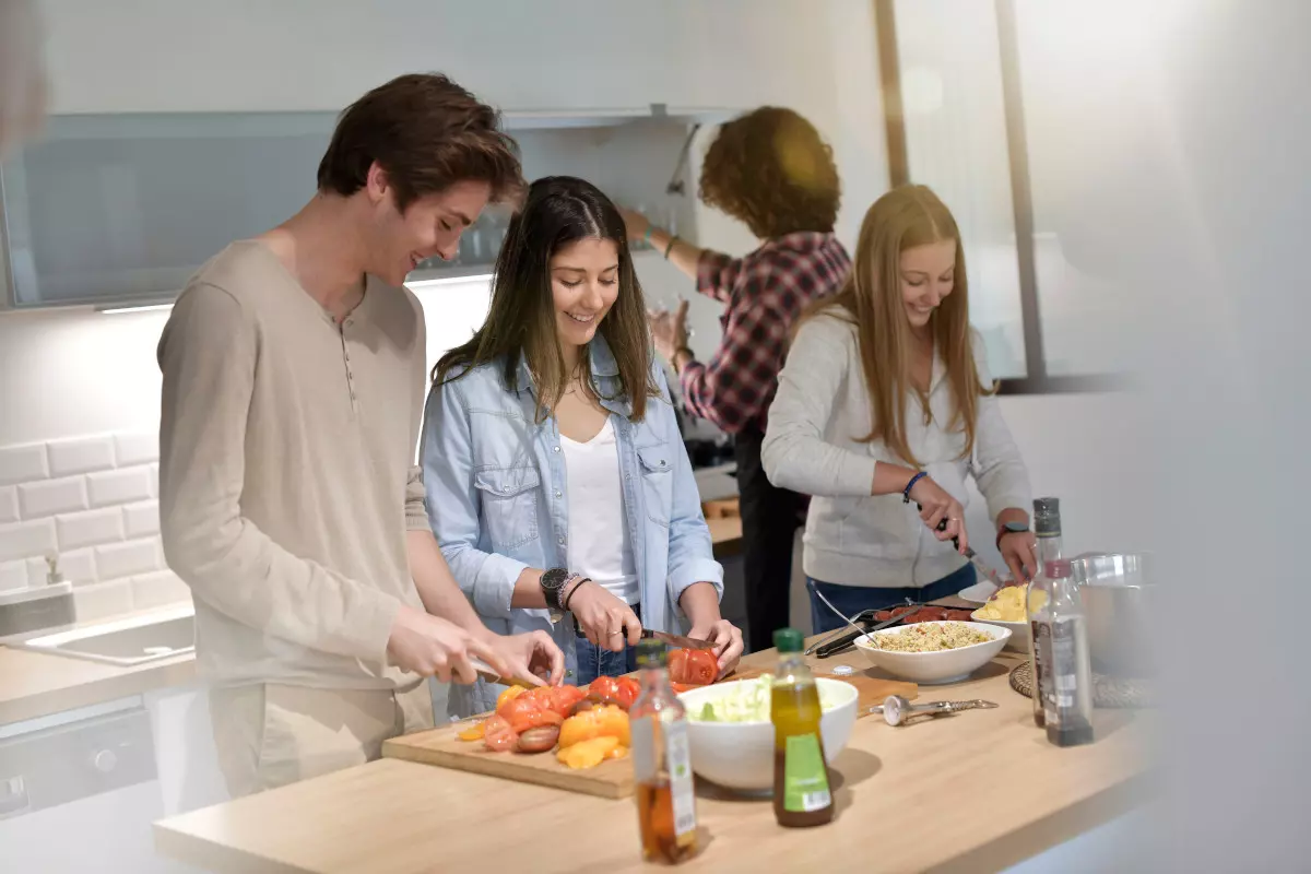 A group of friends meal prepping together. 