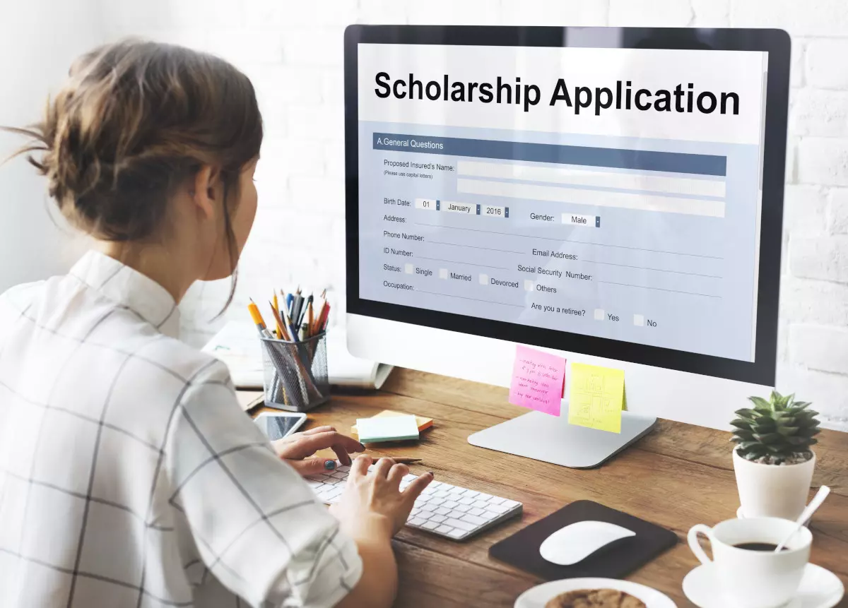 A student applying for a scholarship online.