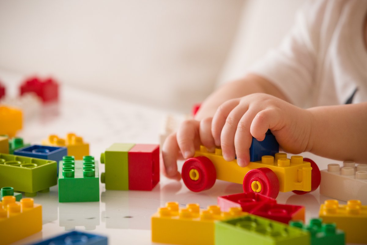 Close up of child playing with toys.