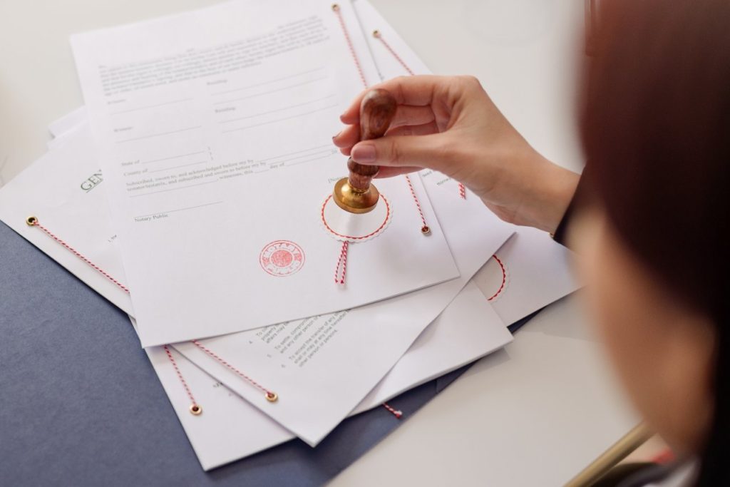Close up of notary stamping documents 
