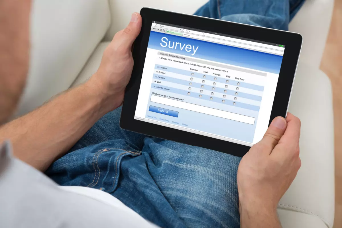 Individual taking online survey on tablet